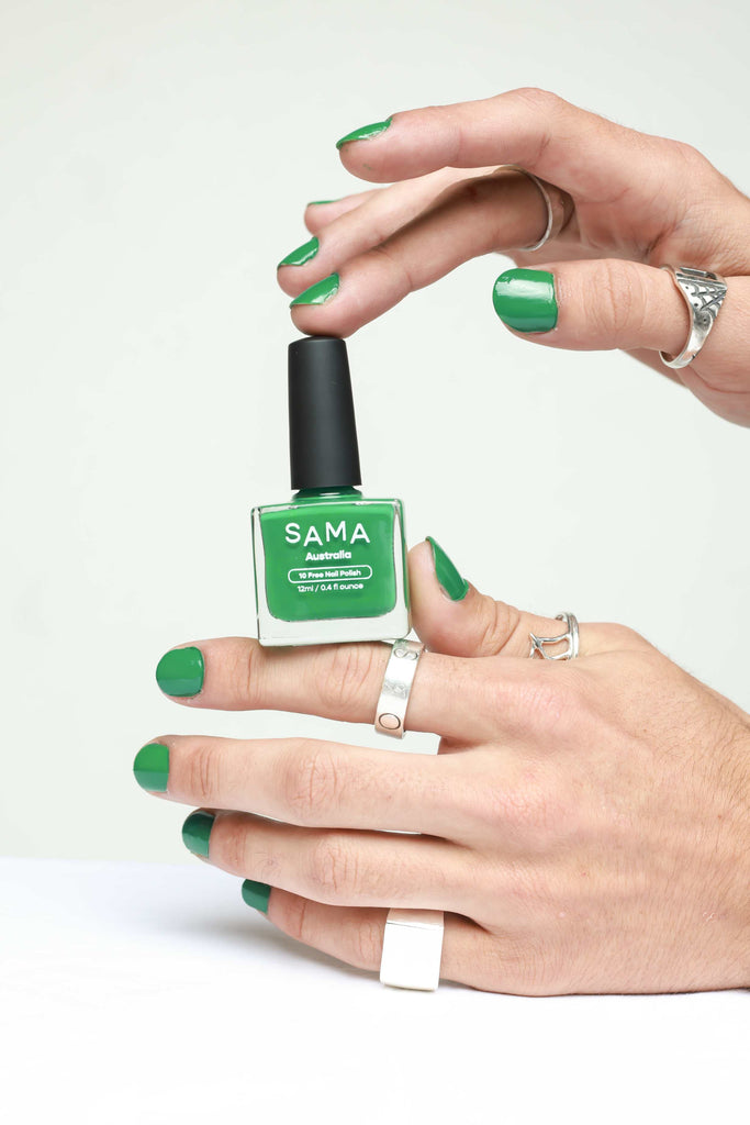 Androgynous hands showcasing green nail polish